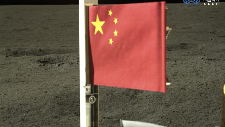 Craft unfurls China’s flag on the far side of the moon and lifts off with lunar rocks to bring home