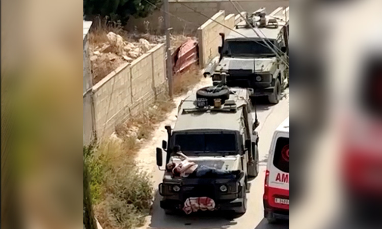 Israeli forces tie wounded Palestinian to jeep in West Bank Israeli forces tie wounded Palestinian to jeep in West Bank raid