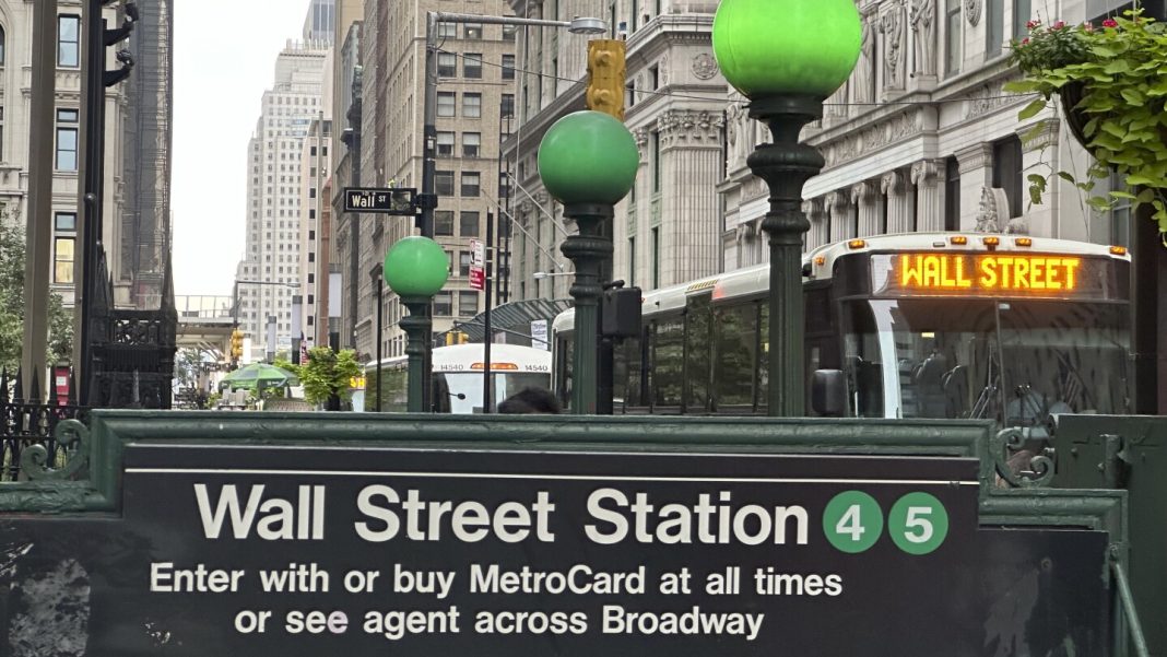 Stock market today: Wall Street edges back from its records as FedEx slumps