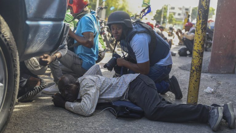 Haiti swears in a new prime minister as gangs open fire at a flight landing in the main airport